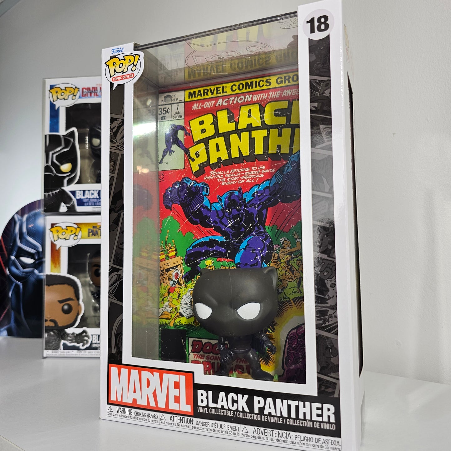 Black Panther Pop! Comic Cover Figure with Case displayed on white desk with other collectibles.